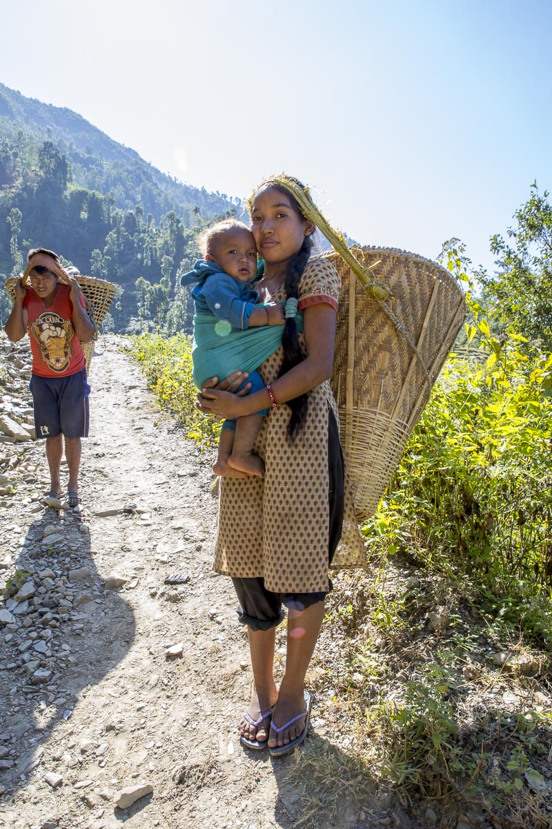 Nepal Sailung - Woman carrying basket and baby on track to Teksingh village - November 8, 2017